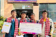 Students posing with their awards after securing the third position in a national-level competition.