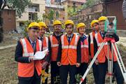 Civil engineering students gaining hands-on experience during a practical field surveying session.