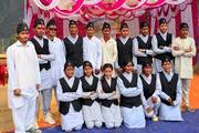 Students dressed in traditional cultural attire during a school ceremony.