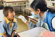 Students undergoing medical check-ups during a school health camp.