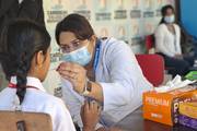 Students receive professional screenings during a dental health camp organized to promote oral hygiene and well-being.