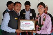 Grade 12 student receiving a certificate of appreciation during the farewell program.