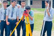 Civil engineering students of Shree Gautam Buddha Secondary School are participating in a practical surveying field session.