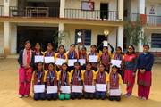 Students posing with their trophies and certificates following a competition.