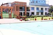 An exterior view showcasing the academic building and campus infrastructure of Hrit Academy.