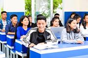 Students engaged in a focused and interactive learning session within a modern classroom environment.