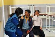 Students undergoing medical check-ups during a school health camp.
