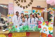 Students presenting clinical models and healthcare projects during an academic showcase.