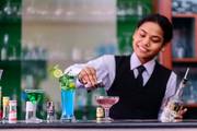 A hospitality student perfecting food and beverage service techniques during a hands-on practical session.