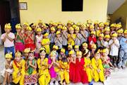 Students celebrating the festival of Krishna Janmashtami in traditional attire.