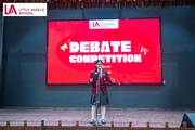 Grade 8 students showcasing public speaking skills during the debate competition.