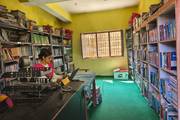 A look inside the library at Latinath Model Secondary School, featuring a wide collection of academic books and reference materials neatly organized for student use.