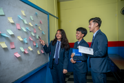 Brainstorming, sharing ideas, and solving problems as a team.