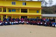 Students with trophies and certificates after their victory in a sports competition organized by the municipality.