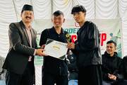 Student receive trophies and certificates during the SEE Futsal Cup 2083 prize distribution ceremony.