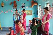 Young learners engaging in interactive and play-based activities within a vibrant nursery classroom setting.