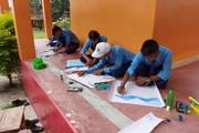 Students participating in a painting competition at Gogal Prasad Model Secondary School.