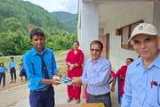 A student of Janaki Secondary School receiving a prize.