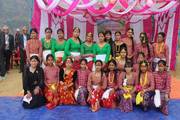 Students dressed in traditional cultural attire during a school ceremony.