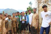 Students and teachers participating in practical rice plantation activities.
