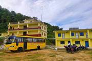 School building and transportation facilities of Shree Jivan Jyoti Secondary School.
