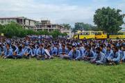 Vibrant School Campus: Students Gathered on the Wide Playground at Nepal Adarsha Secondary School