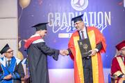 Students and Faculty Shaking Hands at Graduation Ceremony