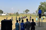 Students of Himalayan Dandapani Neupane Secondary School are participating in a volleyball match during the school's sports event.