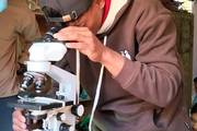 A student using a microscope for practical learning in the science laboratory.