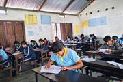 Grade 10 students attending monthly examination