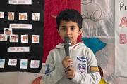 A kindergarten student at Kathmandu Pragya Kunja School during a theme presentation session.