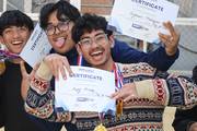 Students with certificates and medals after winning the tug of war competition.