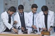 Students conducting a physics practical in the school laboratory at Dibya Deep Jyoti English Secondary School.