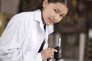 A student conducts a science experiment in the laboratory at Dibya Deep Jyoti English Secondary School.