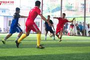 Students participating in a football match during a sports event.