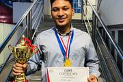 A student being honored with a trophy and certificate for securing the first position in a hardware project competition.
