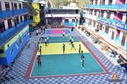 Students participating in a volleyball match as part of the school's extra-curricular activities.