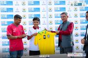 Distributing national team jerseys to students during a World Cup.