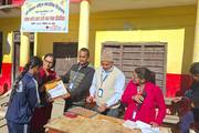 A student receiving an award for the inter-school story writing competition.