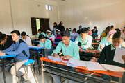Striving for Excellence: Students taking examinations for the improvement of educational quality at Shree Nepal Rastriya Secondary School.