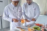 Students engaged in practical culinary training within the specialized Hotel Management Lab.