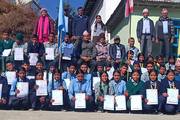 Students and faculty during the certificate distribution ceremony of an inter-school volleyball tournament.
