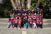 The student body gathers for a group photograph during an outdoor excursion.
