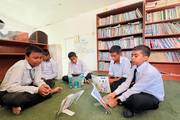 Students explore a diverse collection of books and engage in quiet study within the school library.