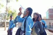 Students participating in a hands-on mathematical learning activity in an outdoor setting.