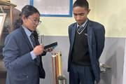 Students actively engaged in a physics experiment to strengthen conceptual understanding through practical learning.