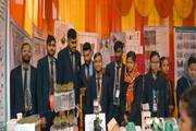 Students showcasing their innovative scientific projects and models during a school science exhibition.