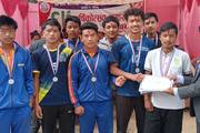 Students receiving medals and certificates for their excellence in sports competitions.