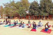 students learning yoga in the school compound