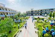students engaging in the weeding program in the school compound